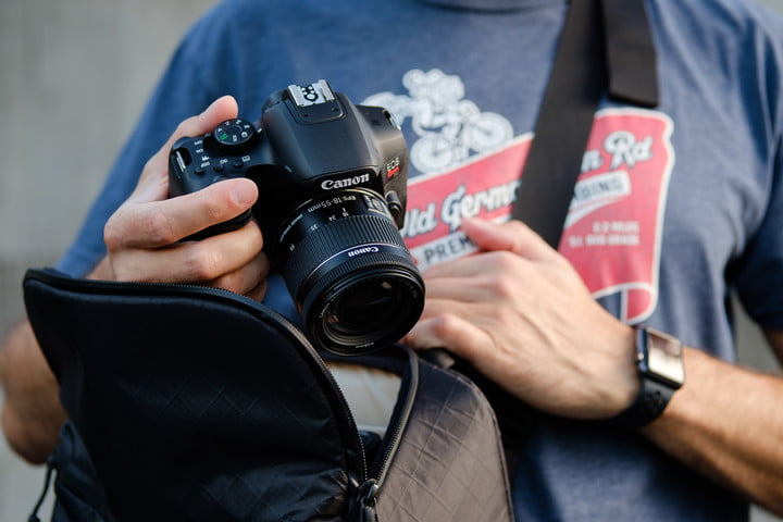 Product photo of Canon EOS Rebel T8i being taken out of camera bag.