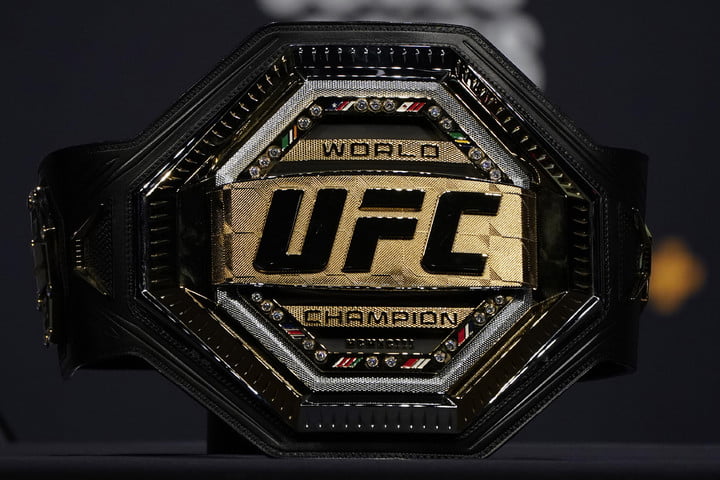 A UFC championship belt sitting on a table.